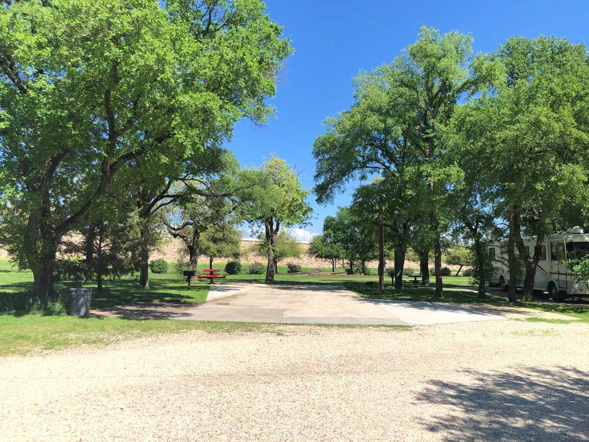 Shaded RV sites under mature oak trees at North Crest RV Park in Waco, Texas